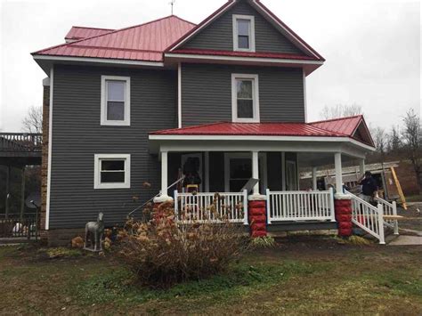 yellow house with charcoal metal roof|red metal roof colors.